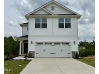 Charming two-story home featuring a two-car garage and stylish white siding at 156 Southern Estates Dr, Sanford, NC 27330