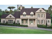Charming brick home boasts a covered porch, balcony, dormer windows, and manicured landscaping at 4812 Parker Meadow Dr, Raleigh, NC 27614