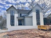 Two-story home with gray siding, white trim, and a black front door at 5208 Knollwood Rd, Raleigh, NC 27609