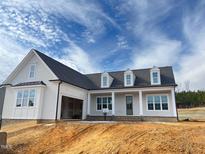 Two-story house with gray siding, white trim, and a covered porch at 6052 Scalybark, Durham, NC 27712