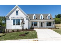 Inviting new construction home featuring a manicured lawn and a long concrete driveway at 6052 Scalybark Rd, Durham, NC 27712