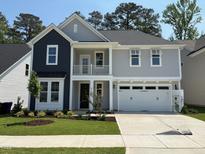 Charming two-story home featuring a balcony, gray siding, black accents, and a well-maintained lawn at 9140 Dupree Meadow Dr # 9, Angier, NC 27501