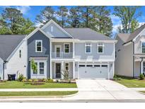 Charming two-story home with a welcoming front porch and attached two car garage at 9140 Dupree Meadow Dr # 9, Angier, NC 27501
