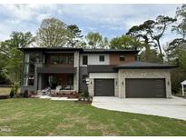 Stunning modern two-story home featuring a two-car garage and a beautifully landscaped front yard at 4123 Rockingham Dr, Raleigh, NC 27609