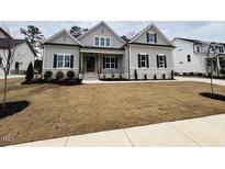 Charming single-Gathering home with manicured lawn and inviting front porch at 165 Inspiration Way, Fuquay Varina, NC 27526