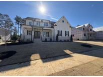 Two story home with white siding, stone accents, and a large front yard at 183 Inspiration Way, Fuquay Varina, NC 27526