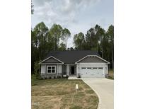 Charming single-story home with stone accents, a two-car garage, and a well-manicured lawn at 60 Lemon Drop Ln, Franklinton, NC 27525