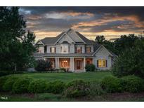 Brick two-story house with a large front porch and manicured lawn at 6366 Lineberry Rd, Liberty, NC 27298
