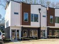 Modern three-unit townhome development with clean lines and a neutral color palette at 1531 Urban Trace Ln, Raleigh, NC 27608