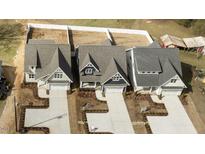 New construction homes feature inviting curb appeal and spacious driveways in a developing neighborhood at 416 S Cross St, Youngsville, NC 27596