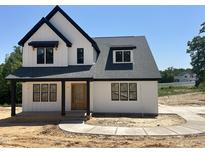 New two-story home features a modern farmhouse design with a black roof and clean white siding at 103 Slocum Dr, Wendell, NC 27591