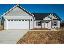 Charming home featuring a large garage and covered porch at 130 Tupelo Dr, Spring Hope, NC 27882