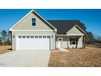 Charming single-Gathering home showcasing a two-car garage, landscaped yard, and inviting front entrance at 146 Tupelo Dr, Spring Hope, NC 27882