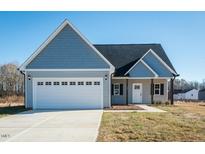 Charming home featuring a two-car garage and inviting craftsman-style front entrance at 300 Yellowwood Ave, Spring Hope, NC 27882