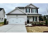 Charming two-story home featuring a spacious two-car garage and classic curb appeal at 175 W Saltgrass Ln, Smithfield, NC 27577