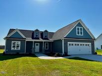 Inviting single-story home with a two-car garage and manicured front lawn at 941 Olive Branch Dr, Smithfield, NC 27577