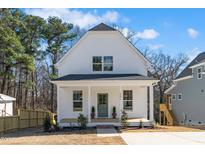 Charming two-story home with a welcoming front porch and beautifully landscaped front yard at 201 N Smith St, Clayton, NC 27520