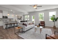Bright, open living space with modern decor, hardwood floors, and seamless flow to the kitchen at 22 Van Winkle St, Lillington, NC 27546