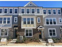Brick front of charming townhome with gray siding and landscaping at 3010 Freewinds Way # 43, Cary, NC 27519