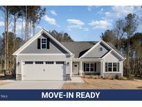 Charming single-Gathering home features a two-car garage, manicured lawn, and classic architectural details at 153 Wilderness Trl, Smithfield, NC 27577