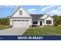 Charming new construction home featuring a two-car garage, manicured lawn, and modern design elements at 607 Tuscany Cir, Princeton, NC 27569