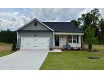 Charming single-Gathering home boasts a well-manicured lawn and a welcoming two-car garage at 234 Danube Dr, Zebulon, NC 27597