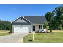 Charming single-Gathering home with a one car garage, landscaped front yard, and covered front porch at 234 Danube Dr, Zebulon, NC 27597