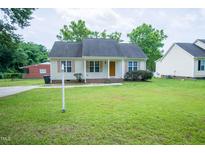 Charming one-story home featuring a well-manicured lawn, classic design, and inviting curb appeal at 310 E Horton St, Zebulon, NC 27597