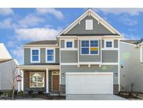 Two-story house with gray siding, white garage door, and landscaping at 26 Steppe Way, Garner, NC 27529