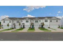 New townhome community with attached garages and well-manicured lawns at 160 Perseus St, Angier, NC 27501