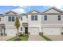 Two-story townhome with gray siding, two-car garage, and landscaping at 168 Perseus St, Angier, NC 27501