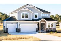 Beautiful two-story home with a two-car garage and stylish stone accents at 644 Barbour Farm Ln, Four Oaks, NC 27524