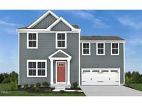 Charming two-story home featuring a modern exterior, a two-car garage, and a neatly maintained lawn at 1581 Ivy Meadow Ln, Zebulon, NC 27597