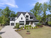 Stunning two-story painted brick home with a manicured lawn and tasteful landscaping at 7417 Dover Hills Dr, Wake Forest, NC 27587