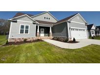 Charming home featuring stone accents, a two-car garage, and a welcoming front porch at 952 Olive Branch Dr, Smithfield, NC 27577