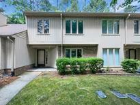 Attractive townhome showcasing brick accents and manicured landscaping at 104 Mossbark Ln, Chapel Hill, NC 27514