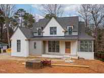 New construction home featuring a painted brick and gray facade, and a covered front porch at 1101 Manchester, Raleigh, NC 27609