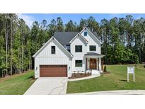Stunning new construction with a board and batten siding, a welcoming entryway, and a three car garage at 100 N Ridge View Way, Franklinton, NC 27525