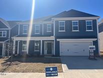 Beautiful new two-story home featuring a two-car garage, large windows, and stylish blue siding at 119 Augusta Pond Way # 147, Raleigh, NC 27603