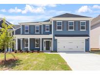 Charming two-story home with a manicured lawn and a two-car garage, perfect for Gathering living at 119 Augusta Pond Way # 147, Raleigh, NC 27603