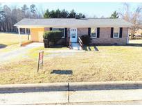 Brick ranch house with carport and a spacious yard at 515 Cody St, Roxboro, NC 27573