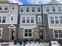 New three-story townhome with gray and stone accents at 3012 Freewinds Way # 44, Cary, NC 27519