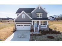 Two-story gray house with white garage door and landscaping at 103 W Star Foal Ln, Wendell, NC 27591