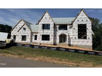 View of construction site of home with exterior weather barrier covering the unfinished facade at 9105 Overlook Crest Dr, Wake Forest, NC 27587