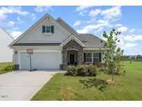 Craftsman style home with stone accents and a two-car garage at 71 Nolan Ct, Lillington, NC 27546