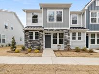 Two-story townhome with gray siding, stone accents, and a front walkway at 448 La Maison Ave # 19, Wendell, NC 27591