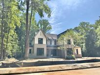 New construction home featuring stone accents and a charming front porch at 7208 Tanbark Way, Raleigh, NC 27615