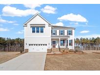 Beautiful two-story home featuring an attached two-car garage, well-kept lawn and landscaped front yard at 100 Bold Dr, Youngsville, NC 27596