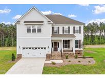 Charming two-story home featuring white siding, brown shutters, landscaped yard, and a welcoming front porch at 100 Bold Dr, Youngsville, NC 27596
