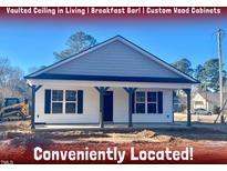 Newly constructed home with gray siding, front porch, and convenient location at 1 Jenkins St, Erwin, NC 28334